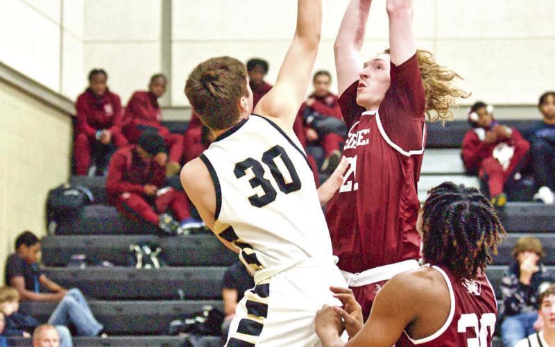 Keegan Callahan contends with a “hands on” defense as he shoots against Silsbee.