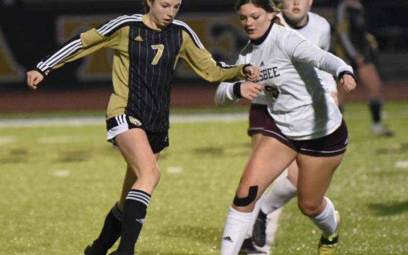 Lady Pirate Chloe Post slips past a Silsbee defender in Tuesday’s district opener in Vidor.. Photo by Randall Luker