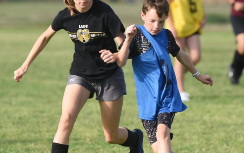 Vidor Junior High plans to field both boys and girls 7th and 8th grade soccer teams in the fall of 2022 competing against a number of other district schools. These youths are practicing at the junior high as part of an intramural league playing many of those same future district opponents. This is the second year for the local teams to play. Volunteer coaches lead the practices as they teach fundamentals of the game in prepartion for the VISD to join UIL play next school year. Photo by Randall Luker