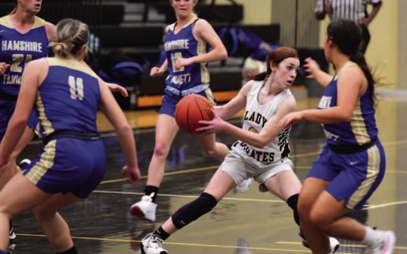 Lady Pirate Railei Mouton #3 looks to pass as she is surrounded by Lady Horns Tuesday. Photo by Randall Luker