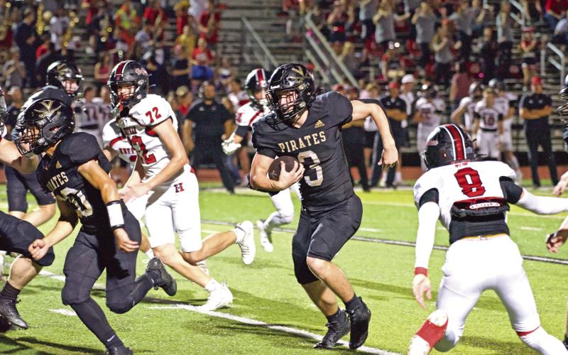 Pirate running back Isaac Fontnow runs left for a first down Friday against the Huffman Falcons.