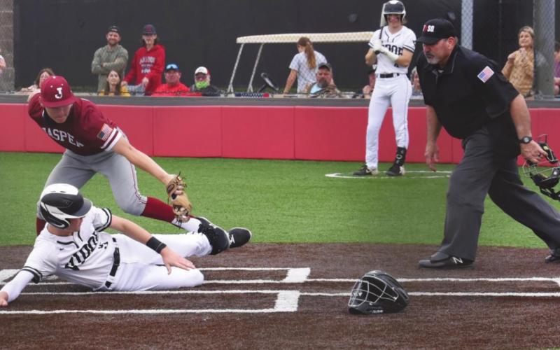 Walker is tagged at home by the Jasper pitcher as he attempts to steal home on a passed ball.
