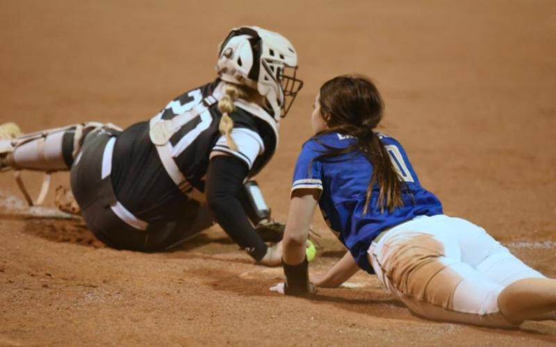 Lady Pirate catcher Allison Simmons narrowly missed tagging out this Hamshire Fannett Lady Horn runner at home on a late throw in Vidor’s home opener last week. Photo by Randall Luker