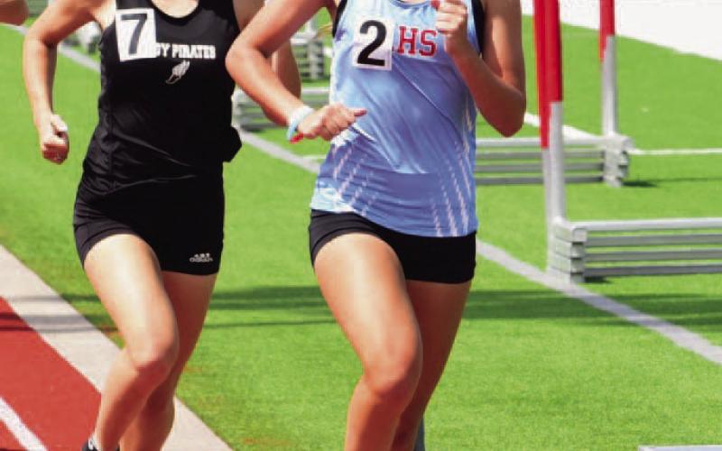 Mia Robin, left, qualified for REgionls in the 800m run. Photo by Randall Luker