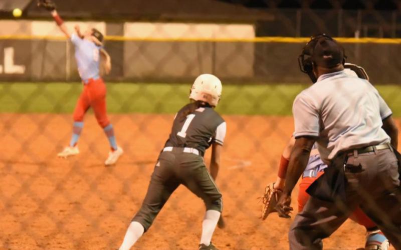 Keaira McCurley pops a hit just out or the pitcher’s reach Friday at home versus Lumberton. Photo by Randall Luker