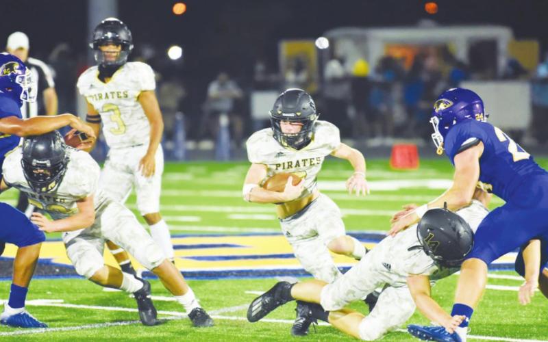 Weston Sepulvado heads upfield as Pirate backs blow a hole through the Blackcat line. Photo by Randall Luker