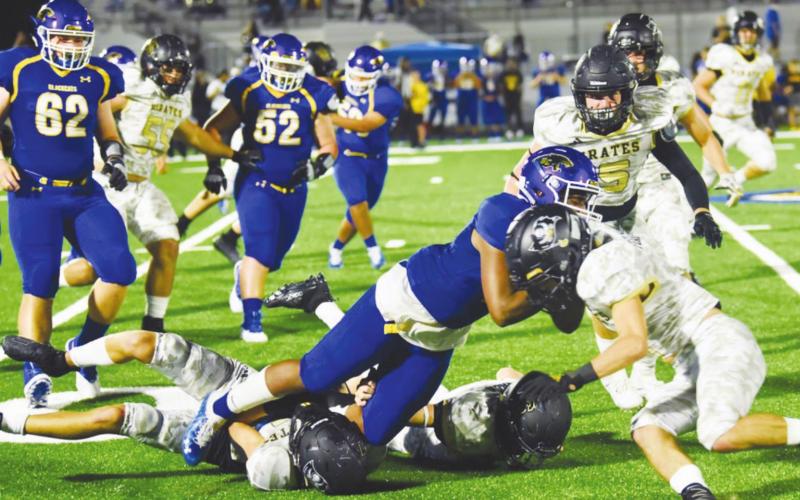 A trio of Pirate defenders bring down a Blackcat receiver. Photo by Randall Luker
