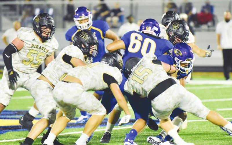 A swarming Pirate defense surround a Blackcat ball carrier. Photo by Randall Luker