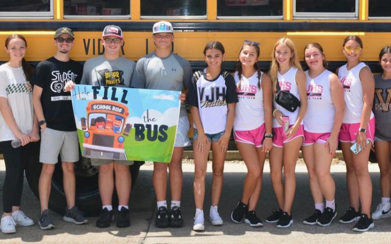 These students collected donations and put away supplies during the second shift of the Fill the Bus event Saturday. Photo by Randall Luker
