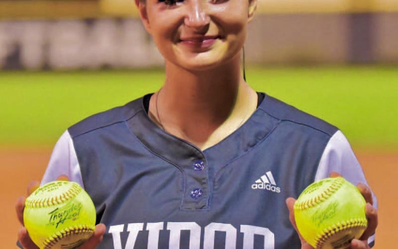 Andreya Garrett holds her two home run balls hit in Friday’s final regular season game. The Lady Pirates now move on to bi-district playoff action. Photo by Randall Luker
