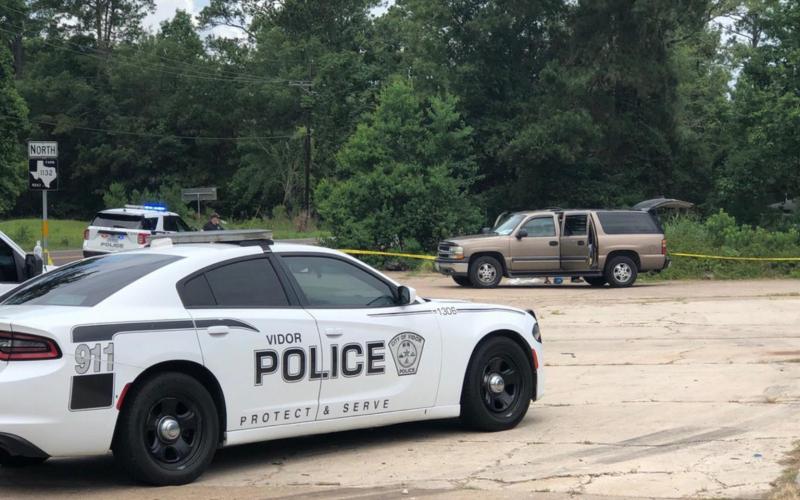 Investigators tape off the area where the body of a Bon Wier man was found Wednesday off FM 1132 near the State Highway 12 intersection. Courtesy Photo