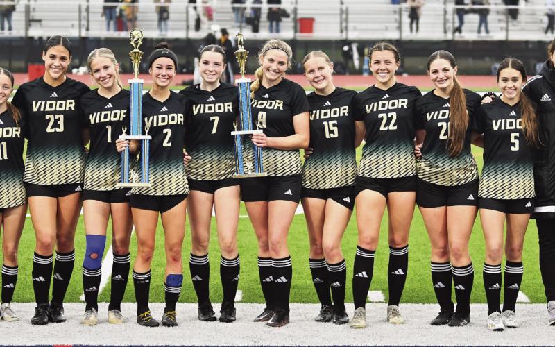 The Vidor Lady Pirates are all smiles as they pose with their two trophies for winning the HJ soccer tournament and scoring the most goals.