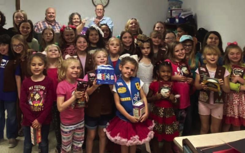 Girl Scouts Troop 130458 made a donation to Living Waters Homeless Ministry (LWHM). LWHM is a ministry of the Source of Old Faith Baptist Church. The girls collected food for the homeless. They also voted unanimously to donate their '10% give back' from their Fall Product sales to the ministry. Danny Beard, founder of LWHM and Mike Tanner, Pastor of the Source of Old Faith Baptist Church were presented with a check. Courtesy Photo