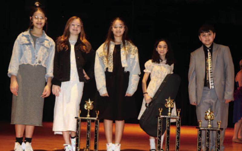 Junior competition winners from left to right: Brylee Lofting, Brynna Loftin and Kortlyn Hennessy won 2nd place for their vocal trio, Hope Nielson won first place for her vocal/instrumental, and William Nele took 3rd place for his piano solo.