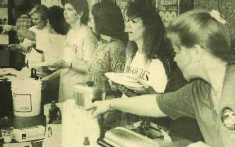 Supporters of the Vidor High School Brigadettes drill team were dishing out pancakes to a hungry public early in front of Woods Supermarket. Late in the morning, they changed to hot dogs, all to raise money for the drill team to go to the Cotton Bowl classic next New Year's Day. Archive Photo