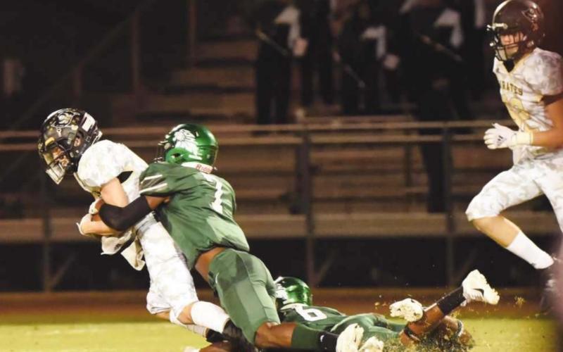 Nathan Bullard drags a pair of Lions as he fights for extra yardage following a pass reception Friday.