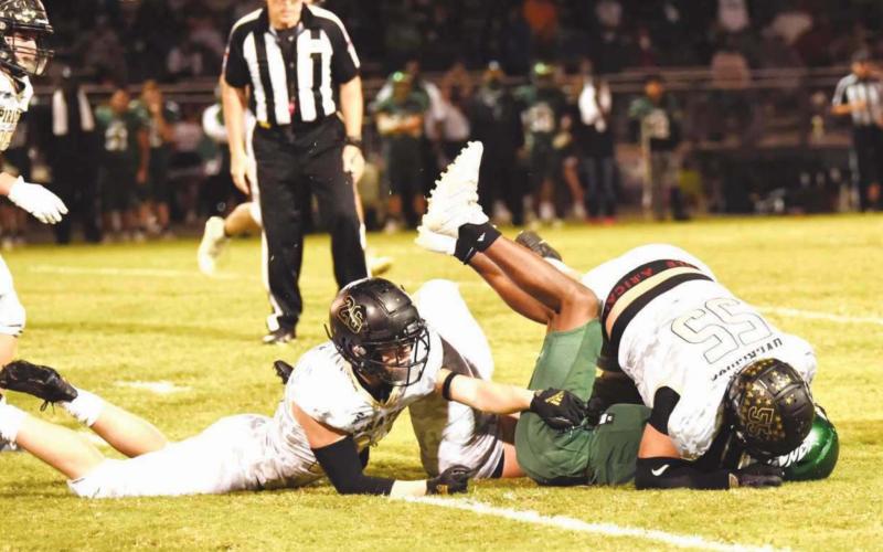 A trio of Pirates-Layne Wilhelm, Colby Smith and Jordan Smith team up to bring down the Livingston QB Friday.