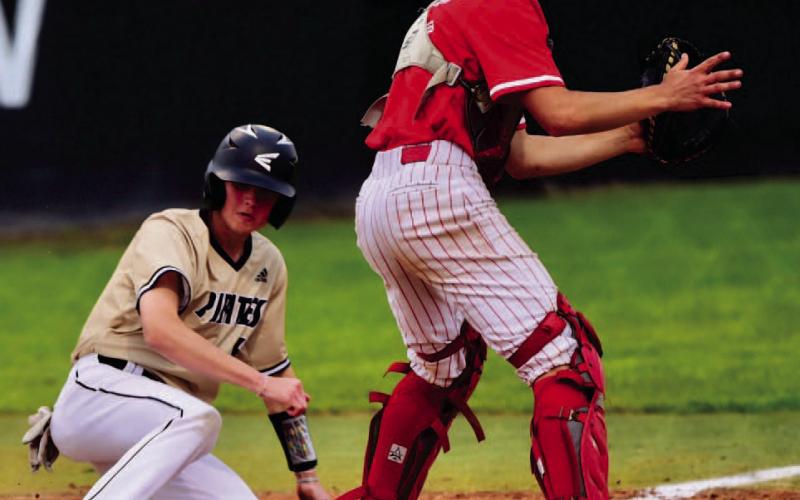 Logan Morris slides in safe at home plate during Vidor’s late rally versus Bridge City. Photo by Randall Luker