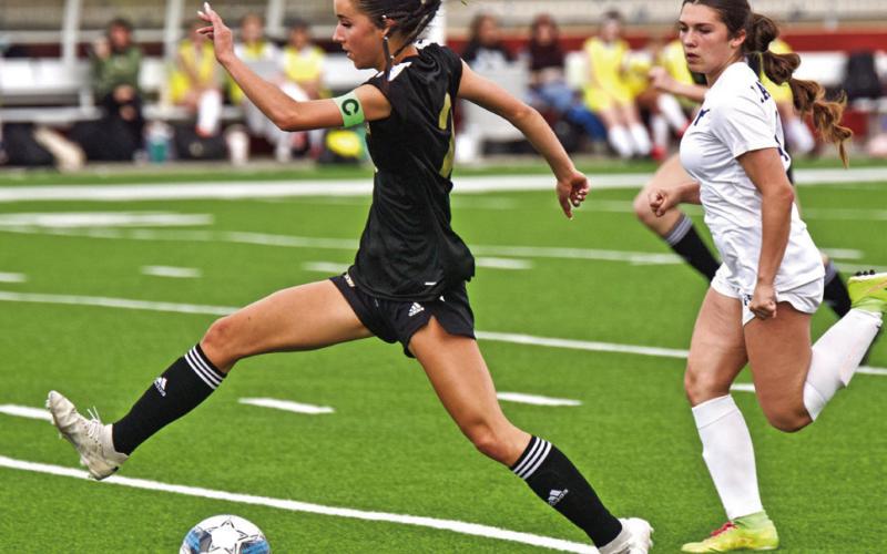 Taylor Bull drives on the goal to score.