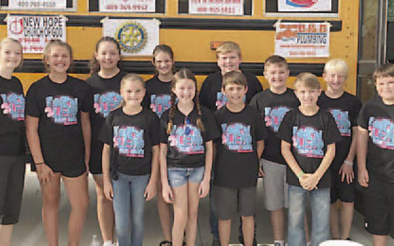 Before the Fill the Bus School Supply Collection Drive was postponed last Saturday morning, the Vidor Middle School Pirate Council posed for this picture in front of the big yellow school bus parked in the Walmart parking lot. But, grey clouds were forming and getting ready to open up with lightning and rain. Archive Photo