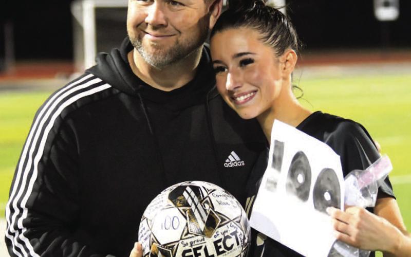Vidor Head Girls Soccer Coach Ralph Fields poses with VHS senior Taylor Bull after she scored her 100th career goal last night versus Silsbee in this season’s first district game. “Taylor has been a dominant scoring threat for the Lady Pirates as she currently leads the team in scoring so far this season with 16 goals and she broke the school’s single season scoring record last year scoring 45 total goals,” Fields said.