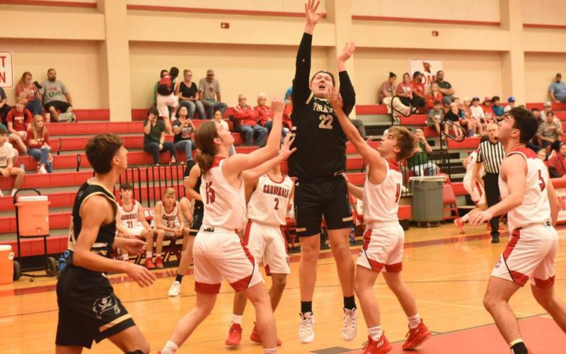 Dalton Cash, 6’4” Pirate senior, shoots and scores Friday in the Pirates district opener in Bridge City. Photo by Randall Luker