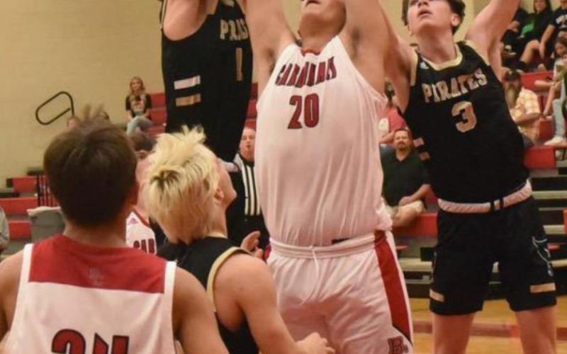 Pirate Zander Lindsey, #11, takes a shot as teammate Colby Eaves, #3, awaits a rebound. Photo by Randall Luker