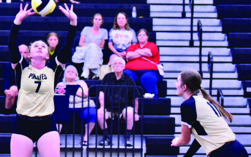 Natalie Morison sets the ball for Madison Powell in the Lady Pirates home game versus Hamshire Fannett. Photo by Randall Luker