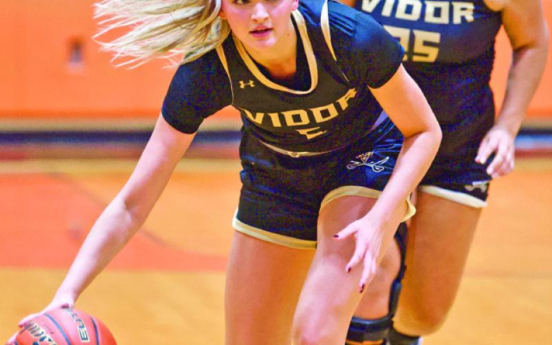 Bringing it down Senior forward Raegan Stephenson checks out the Orangefield defense as she brings the ball down followed by Laikyn Brodnax.