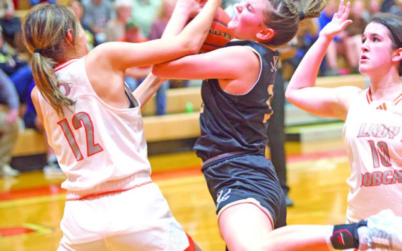 Hard fought game Allie Williams battles for the rebound with an Orangefield Lady Bobcat in the Lady Pirates win Tuesday night.