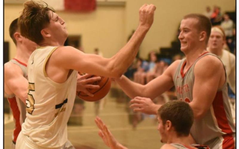 Joe Gardenhire is met with a wall of Raiders as he attempts to shoot in Tuesday’s home game. Photo by Randall Luker