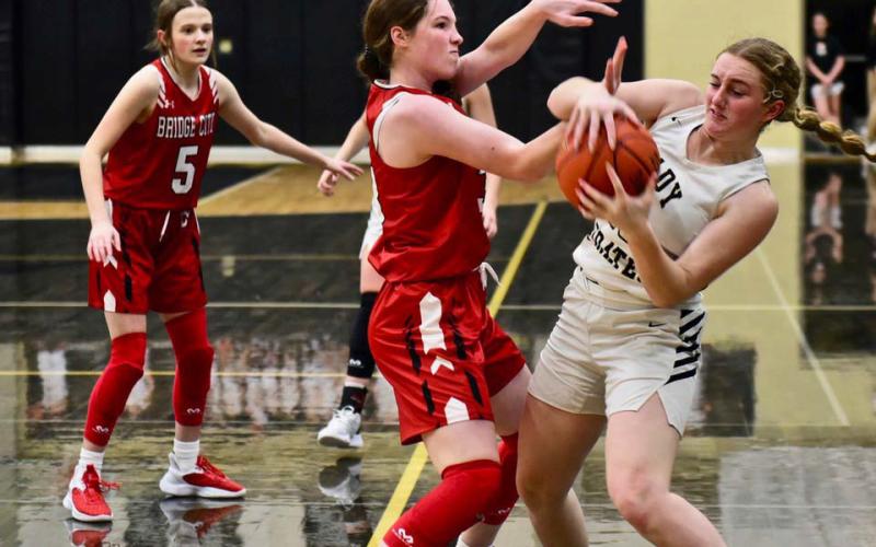 Natalie Morrison fights to retain possession of the ball versus Bridge City. Photo by Randall Luker