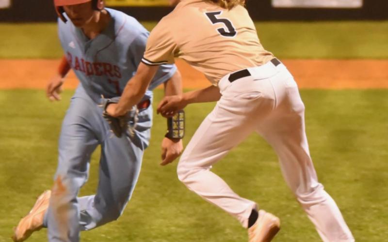 Pirate pitcher Reagan Hallmark tags a Lumberton runner trying to steal home in Friday’s district game. Photo by Randall Luker