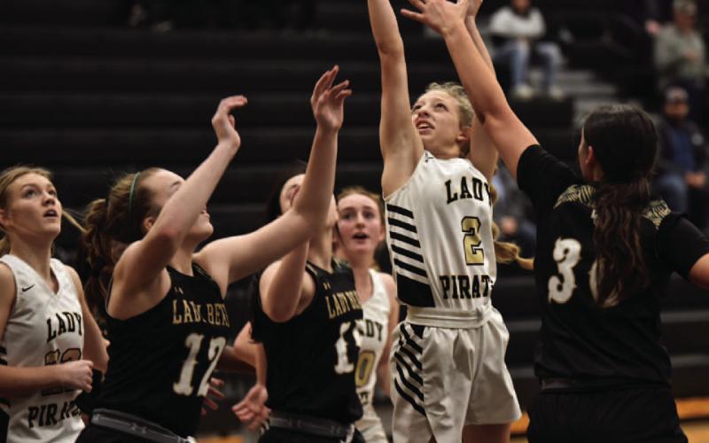 Senior Lady Pirate Mia Robin takes her shot while surrounded by Lady Bears. Photo by Randall Luker