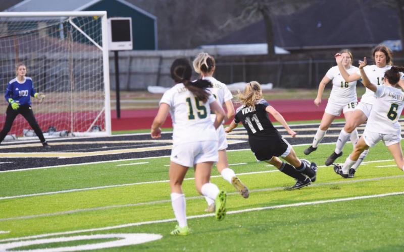 Vidor’s Brooklyn Healy sends her 100th career goal toward the net in Friday’s match with LCM.