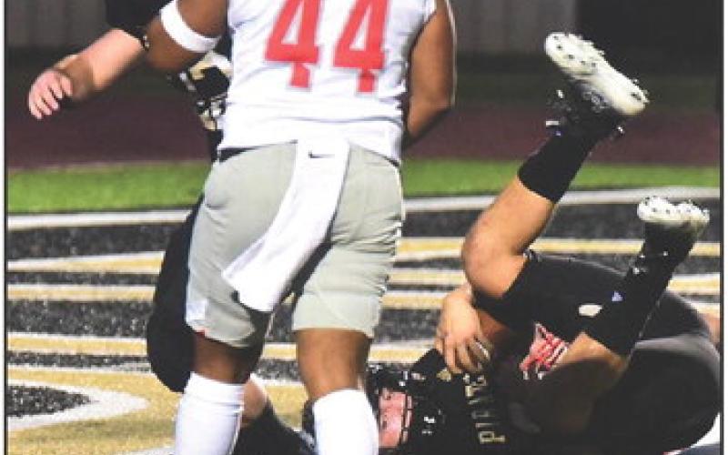 Jarrett Odom is upended as he scores a touchdown. Also pictured is blocking back Caleb Dean. Photos by Randall Luker