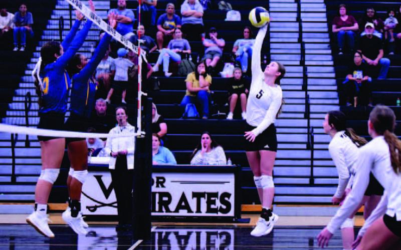 Varsity Lady Pirate Madison Powell readies her return versus the Lady Tors Tuesday. Also pictured are Lady Pirates Brilie Cornelison and Jaden Lee.