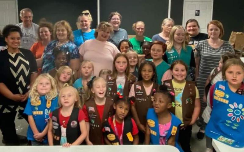 Local Vidor Girl Scouts troop130458 had a food drive for Christian Care Center and then went and filled 401 bags for Thanksgiving and Christmas dinner to local residents in need. Courtesy Photo