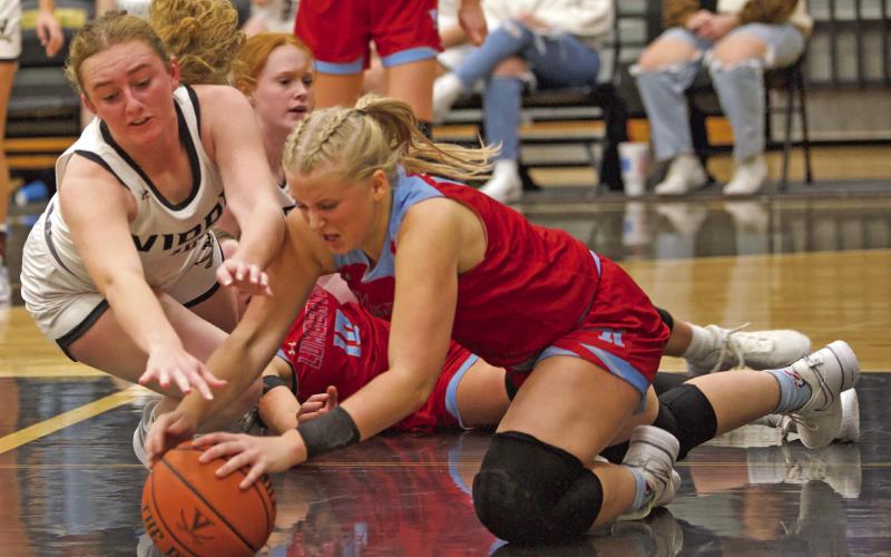 Scramble for Possession Lady Pirate Natalie Morrison and a Lumberton Lady Raider go to the floor for possession of a loose ball Wednesday in a district match.