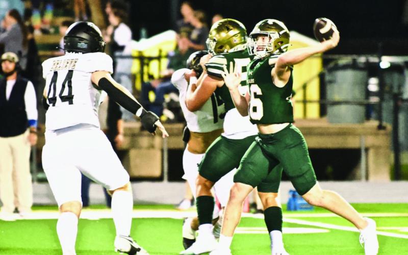 Tate Ardis, #44, and Blayden Laughlin, #15, pressure Bear QB Dylan Payne in Friday’s overtime loss to the Bears.