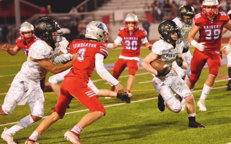 Pirate RB Weston Sepulvado runs between two Raider defenders.