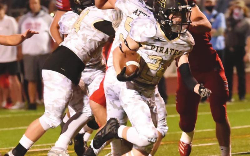 Chase Stansbury blows through the Raider offensive line on his way to a Pirate TD Friday night.