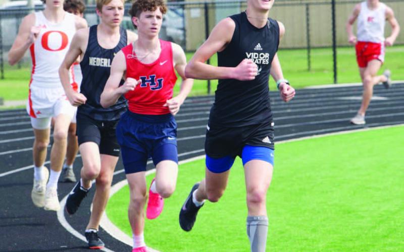 Branson Healy, front, placed 2nd in the 3200 meter run with time of 11:19.50 at the Bridge City relays Thursday. Photo by Randall Luker