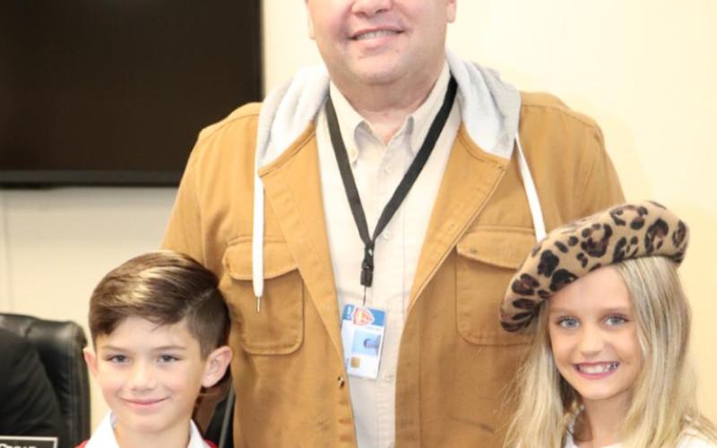 Recognizing Mr. Mike Helms were Vidor Elementary students Noah Fox and Bella Fultz.