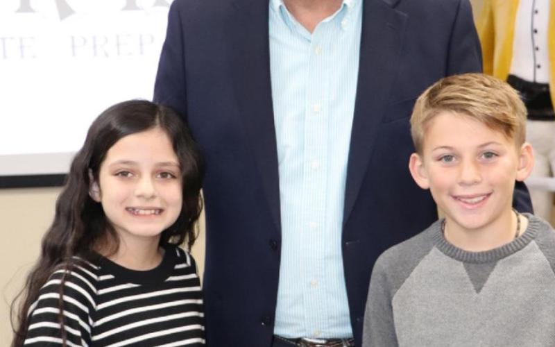 Mr. Rollie Burr was honored for his longtime Board of Trustees service by Vanessa Saavedra and Corbin Marcantel from Pine Forest.