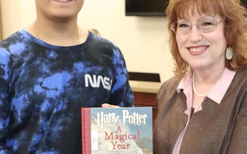 Honoring Ms. Gina VanDevender with a book was Coby Roark from Vidor Middle School.