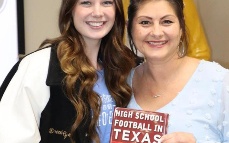 Carrie Vincent received a book from Vidor High School senior Brooklyn Bushelle.