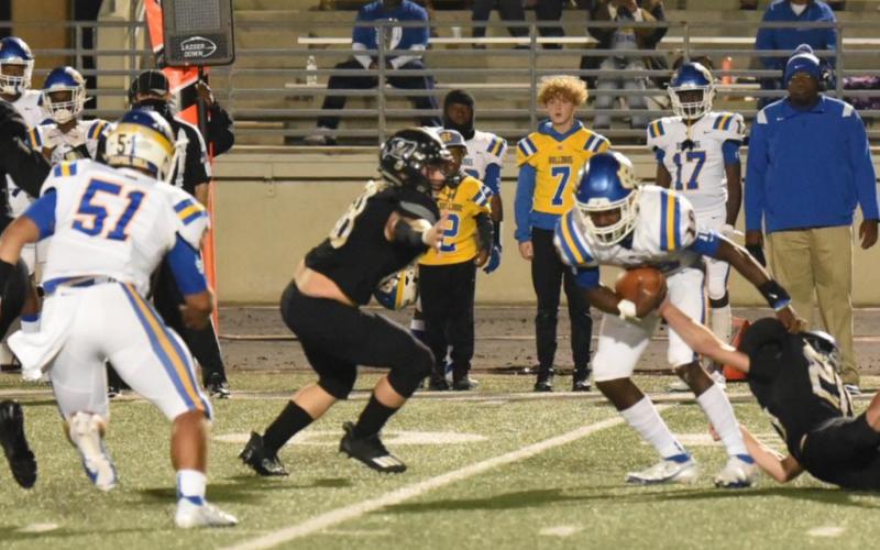 Lane Copelan, #20, right, manages to get a grasp on Chapel Hill QB Demetrious Brisbon as #68, Tyler Rojas, approaches to help. Jordan Smith, #99, moves to seal the outside. Photo by Randall Luker