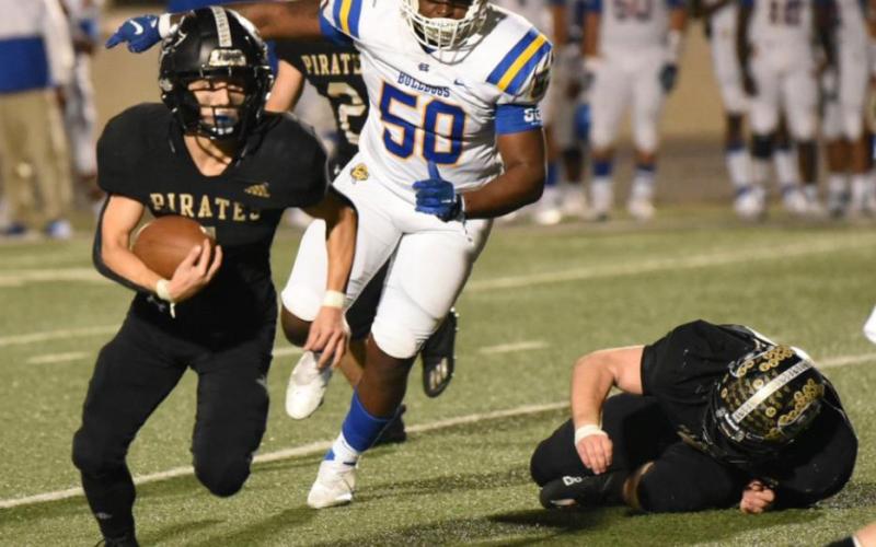 Christopher Dilley turns up field for a big gain in Friday’s bi-district playoff. Photo by Randall Luker