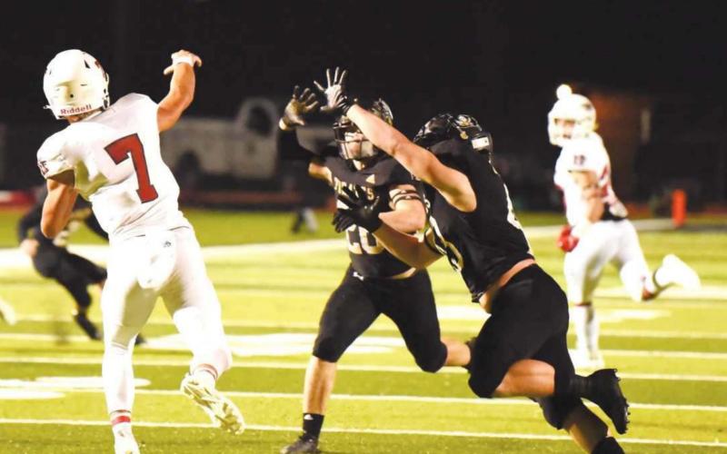 Pirates Layne Wilhelm and Colby Smith rush Falcon QB Luke Thomas.